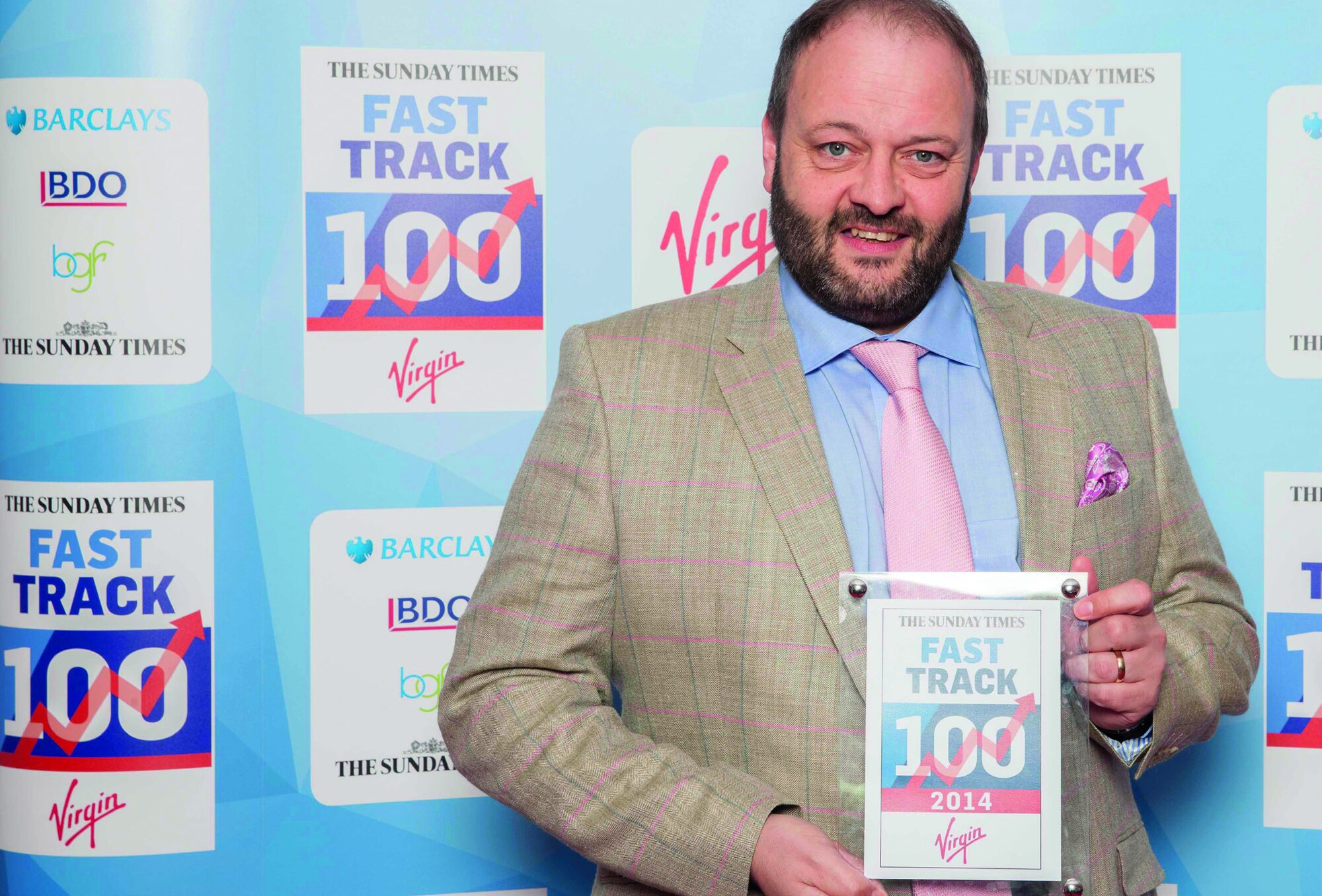 Terence Hillier holding a Sunday Times Fast Track 100 plaque